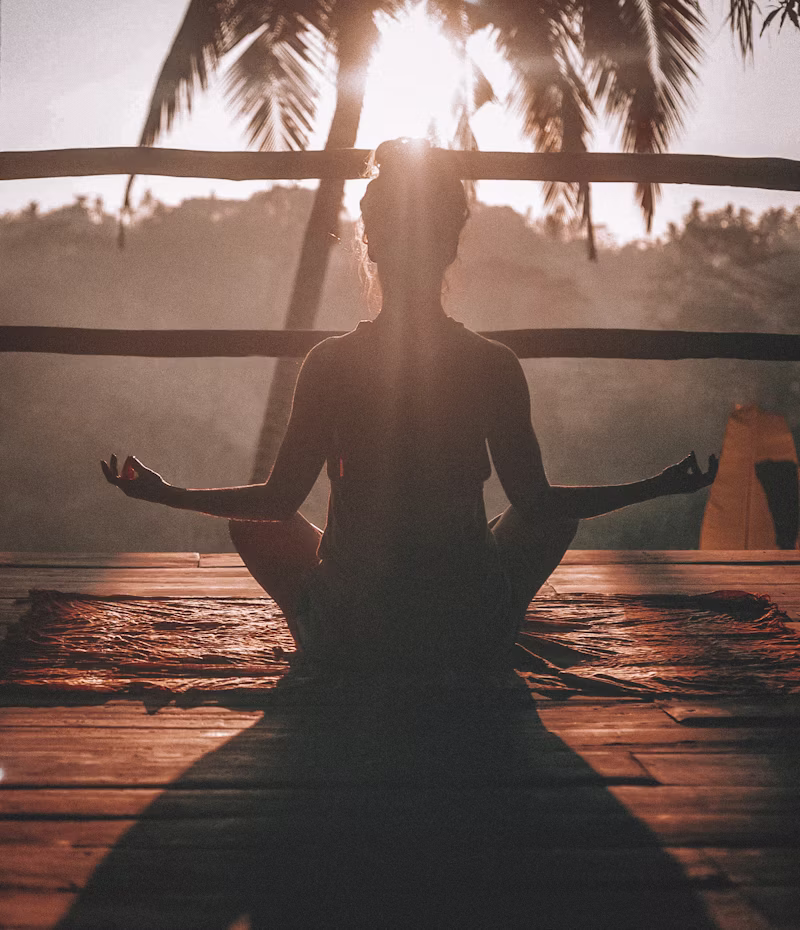 Mindfulness yoga instructor breathing deeply during sunrise